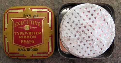 EXECUTIVE TYPEWRITER RIBBON TIN WITH A RIBBON INCLUDED, STILL WRAPPED IN FOIL